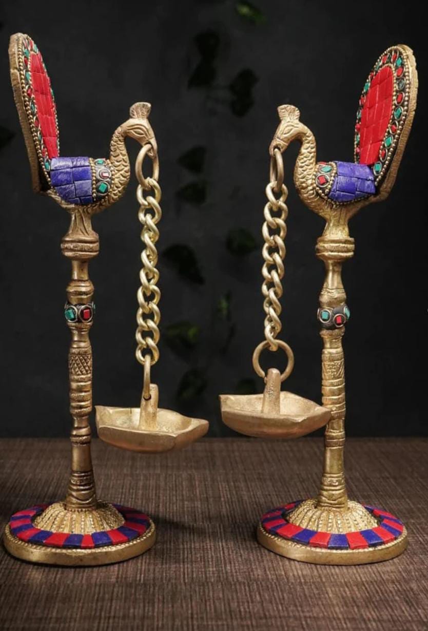 Brass peacock lamp with hanging Diya