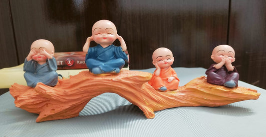 4 Baby Monks on a log